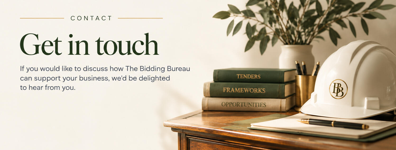 The Bidding Bureau The Bidding Bureau contact graphic featuring construction tender books, a hard hat and stationery.